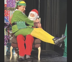 Buddy (Andrew Eiden) loves to hear a good story from Santa (Shayan Barati) in “Elf The Musical” at the Ojai Art Center Theater, running weekends through Dec. 18.